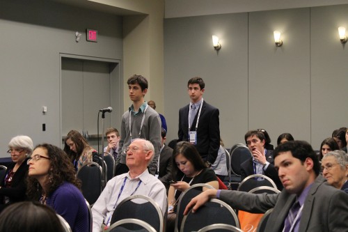 Yossi attentively listens after asking a question during a breakout session.