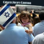 A young supporter waves an Israeli flag.